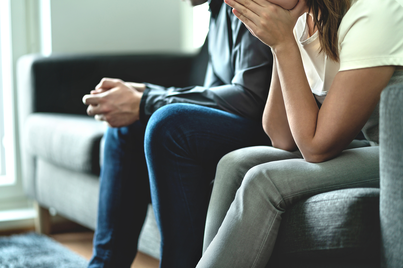 A woman sits next to a man on a couch while crying into her hands. Dealing with emotional abuse and wanting to move past it? Our trauma therapist in Austin, TX can help you.