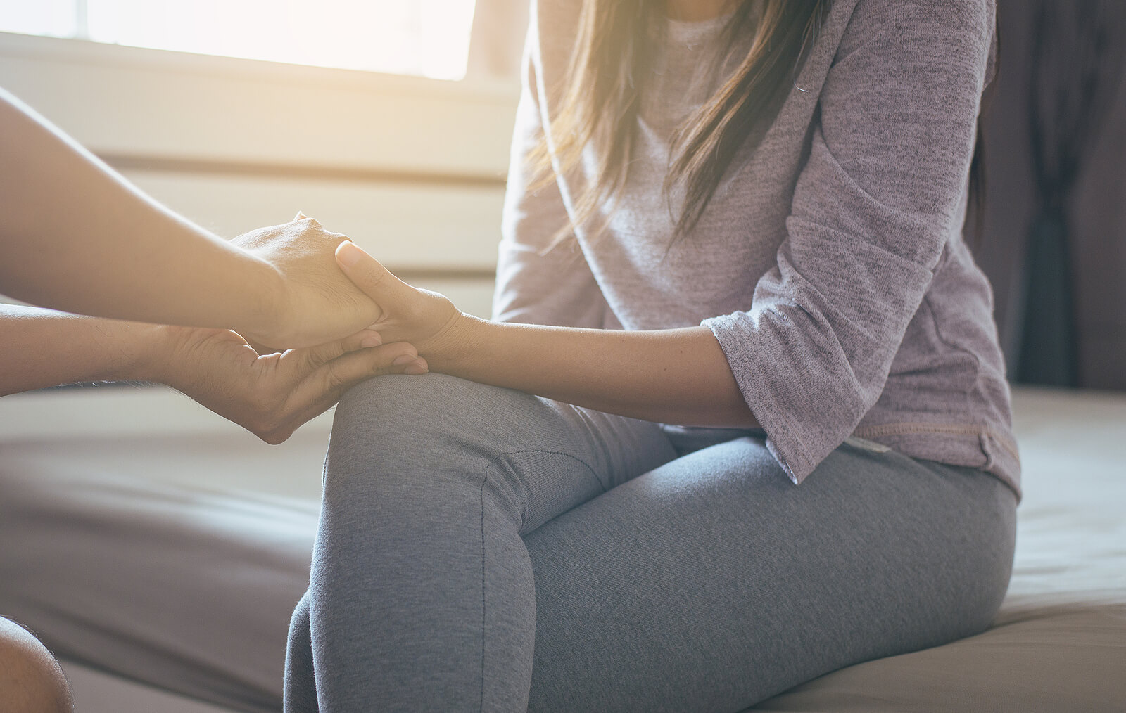 A woman's hand is being held as she is comforted by another person. Trying to find comfort and move past your relational trauma? Individual therapy for relationship issues in Austin, TX can help you move forward from your trauma. Speak to a relationship therapist in Texas today!