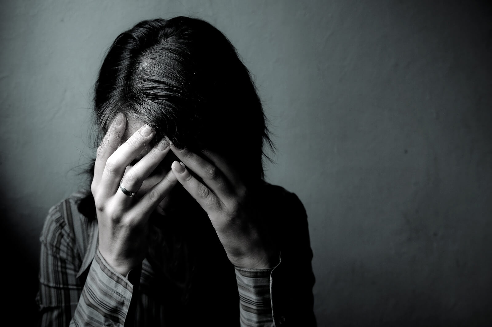 A woman cries into her hands. Trying to move forward from emotional abuse in Austin, TX? It might be time to speak with a trauma therapist in Texas today.